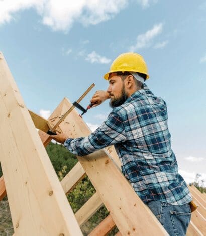 Construction worker building a roof frame.