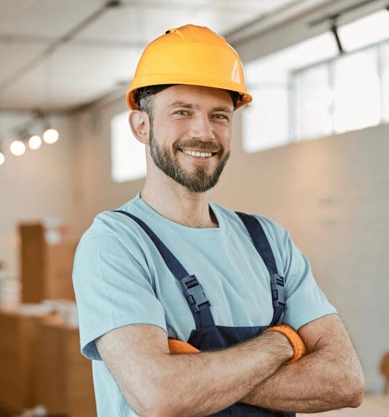 Smiling construction worker in hard hat.