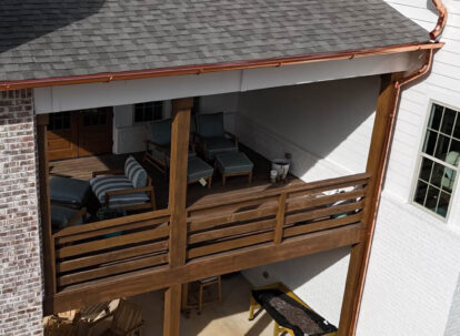 Copper gutters and a wooden deck.