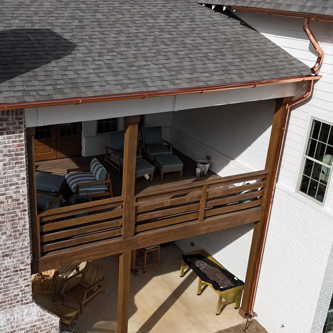 Copper gutters and a wooden deck.