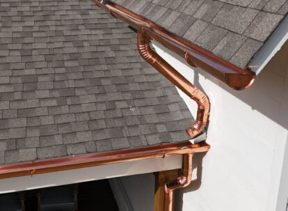 Copper gutters and gray roof shingles.