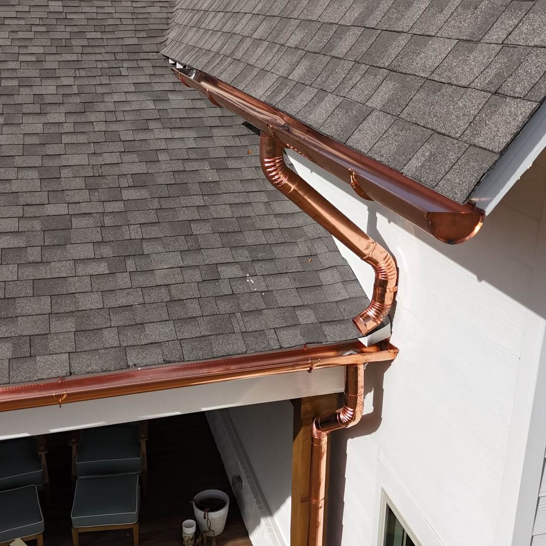 Copper gutters and gray roof shingles.