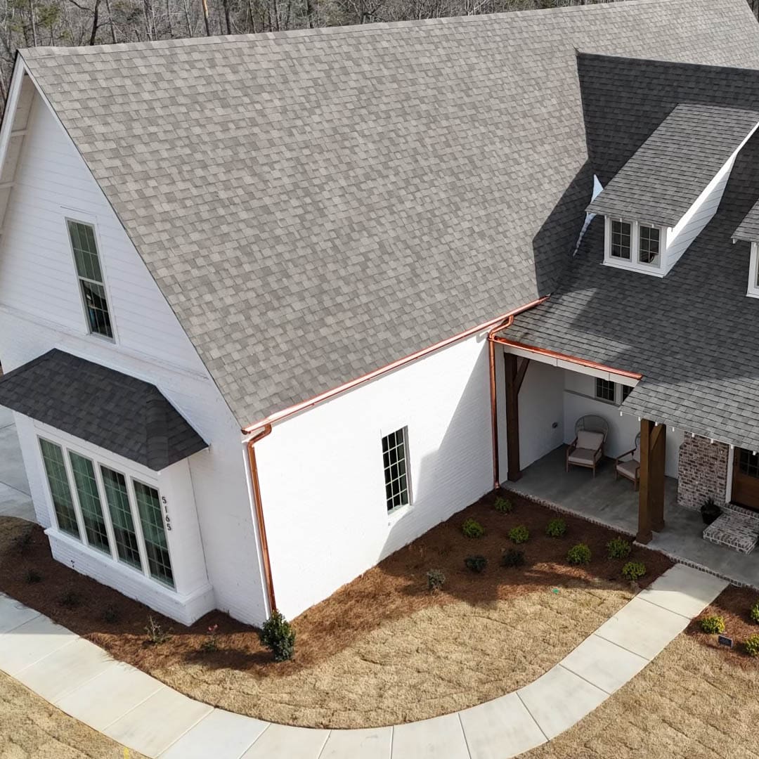 White farmhouse with copper gutters.